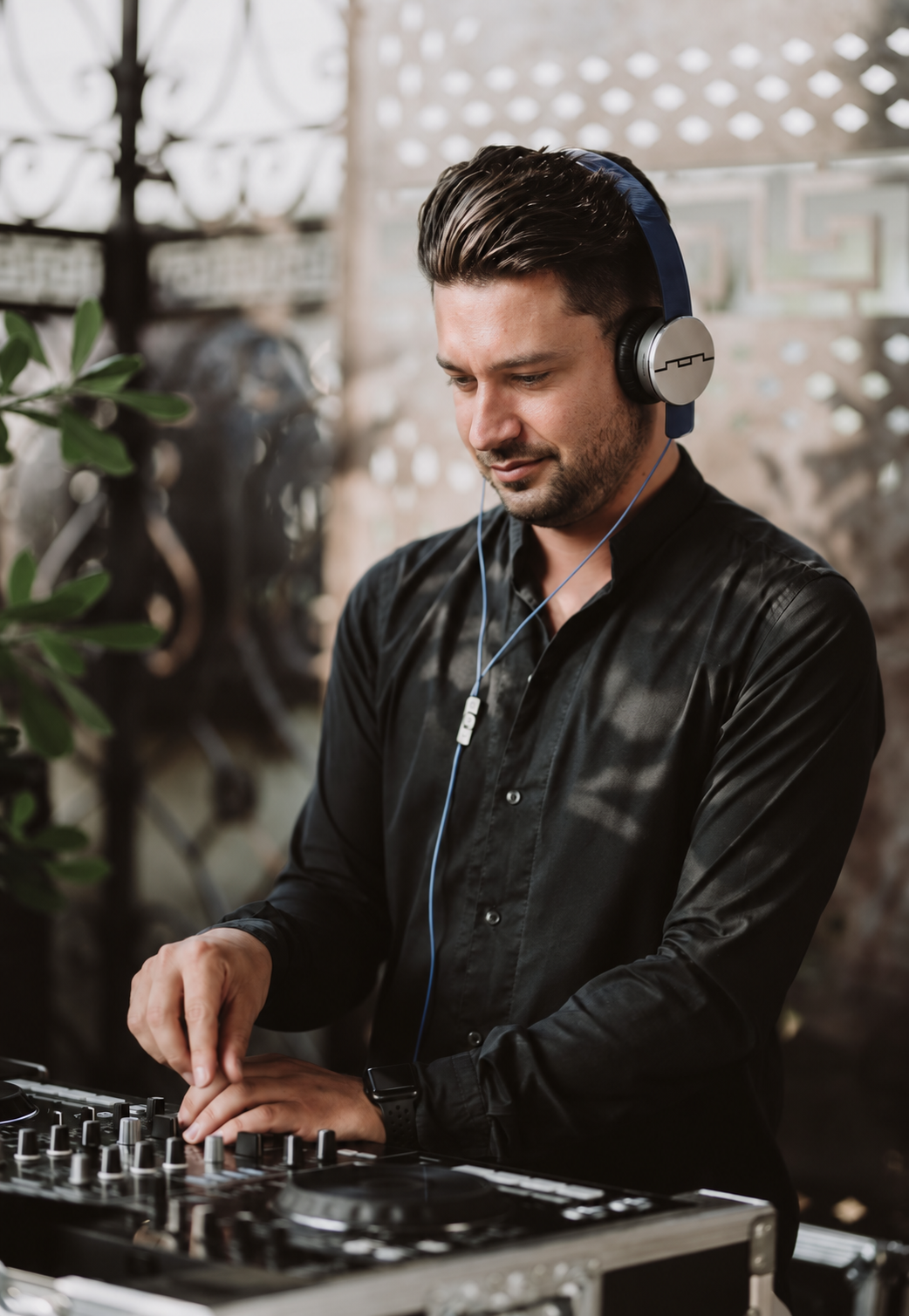 Dennis mixing music at his DJ console